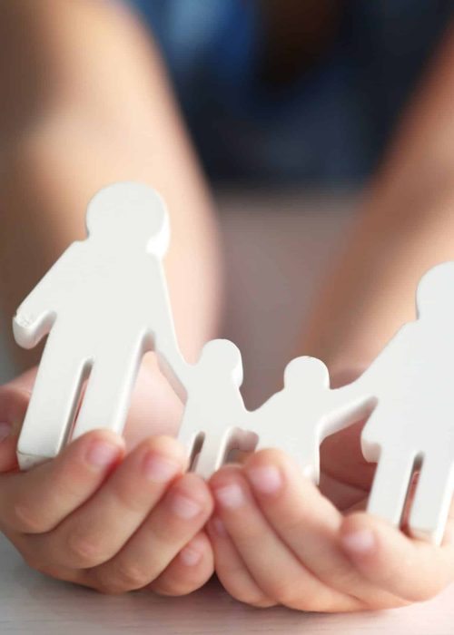 Child,Holding,Figure,In,Shape,Of,Happy,Family,,Closeup.,Adoption